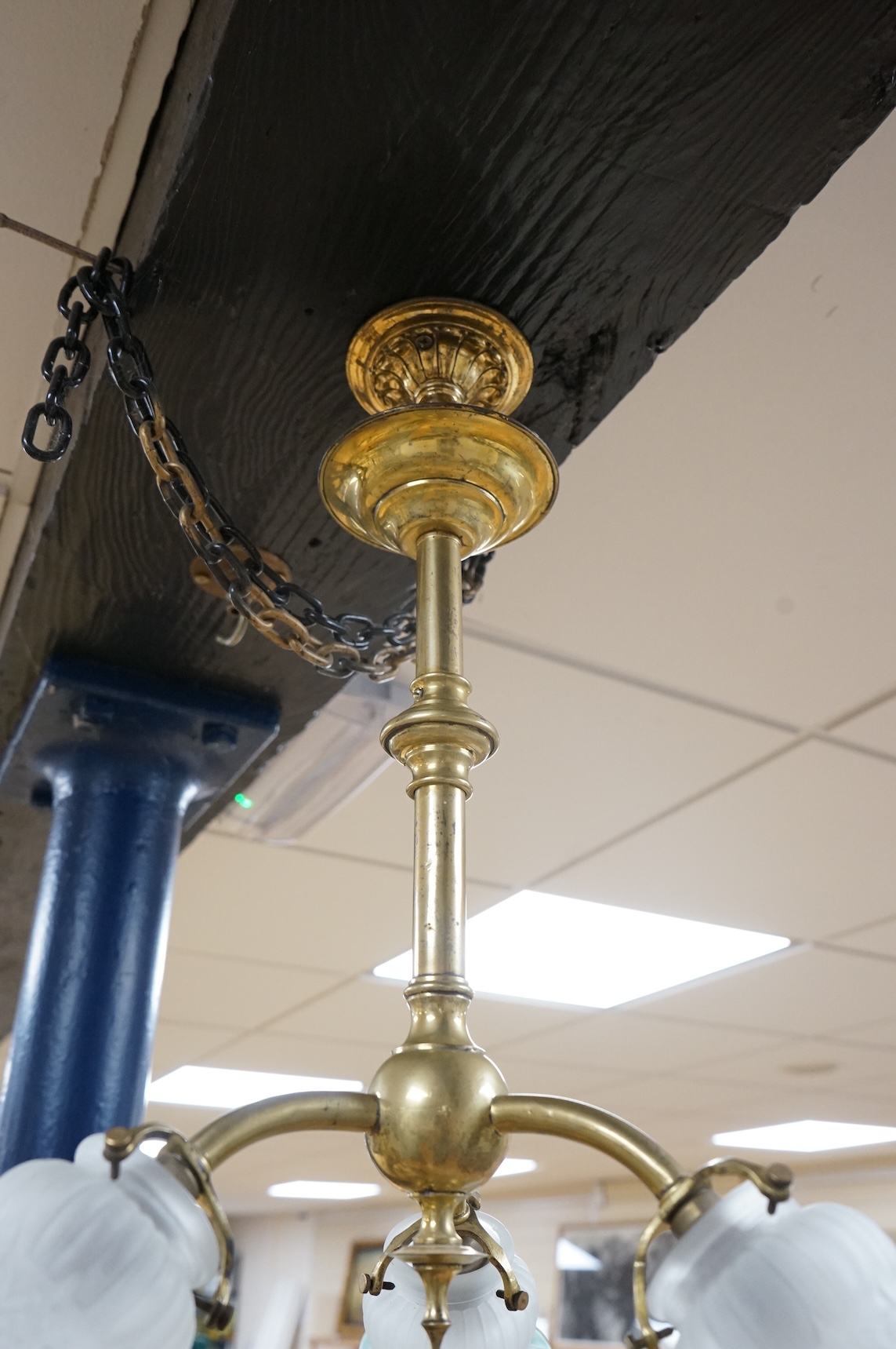 A brass three branch frosted shade ceiling light